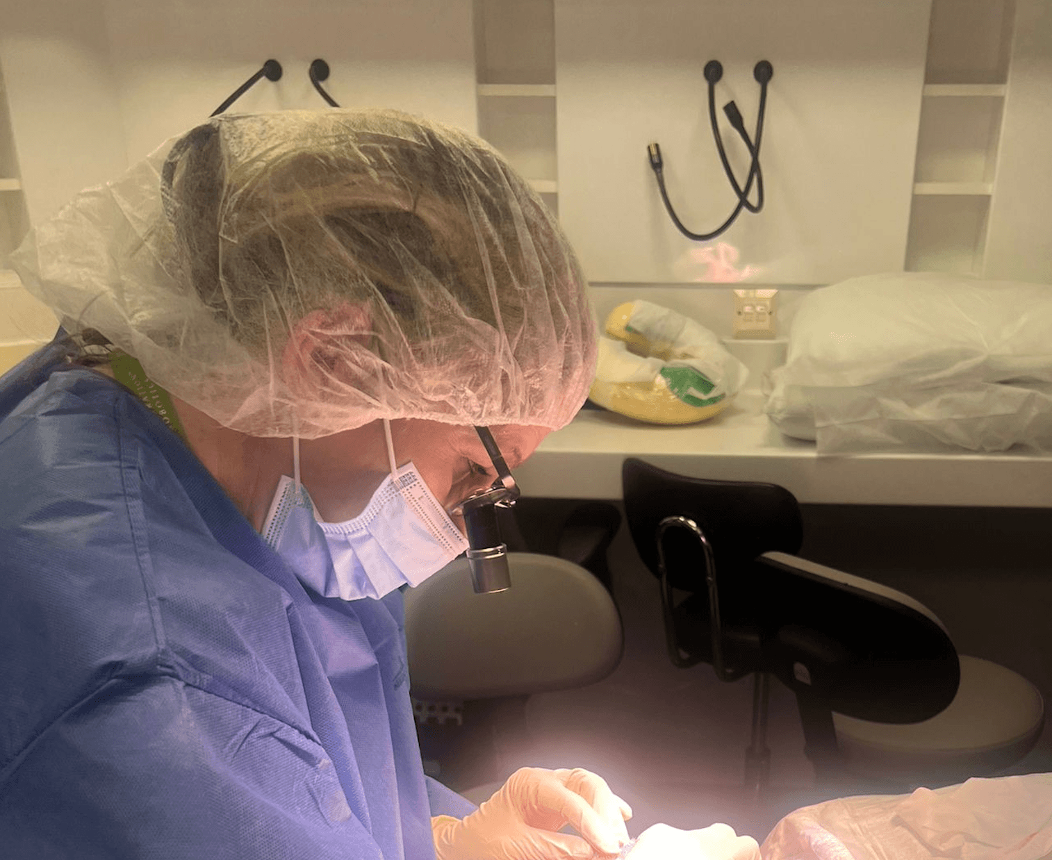 A hair transplant surgeon at the Farjo Hair Institute performing surgery on a botched hair transplant.